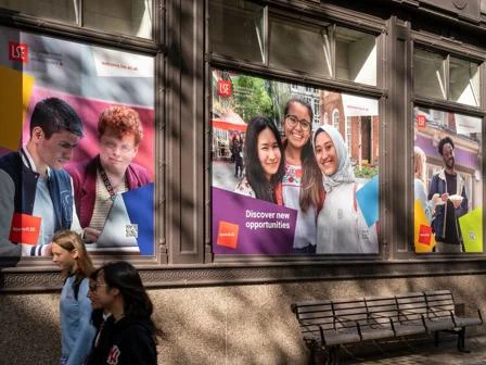 Students walking past LSE banners on campus