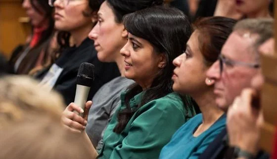 woman holding microphone in audience