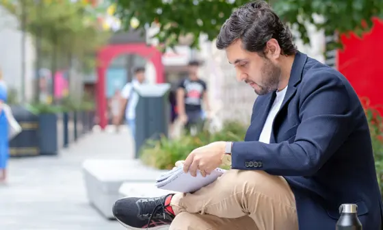Student sitting with a notebook