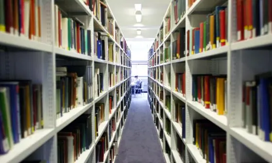 A view of LSE Library from between bookshelves.