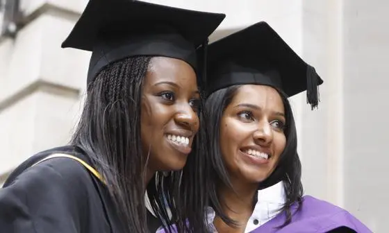 Two students in graduation robes