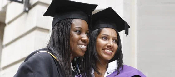 Two students in graduation robes