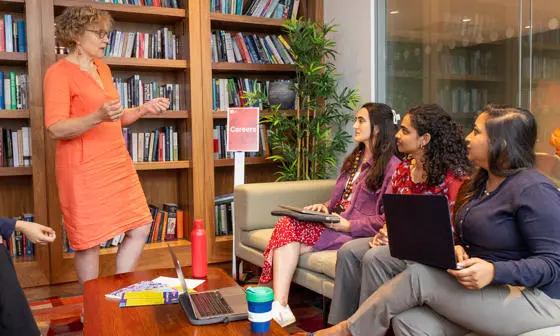 A careers advisor talks to students
