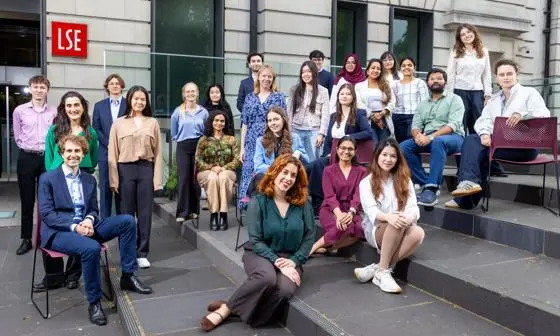 A large group of students on steps outside an LSE building