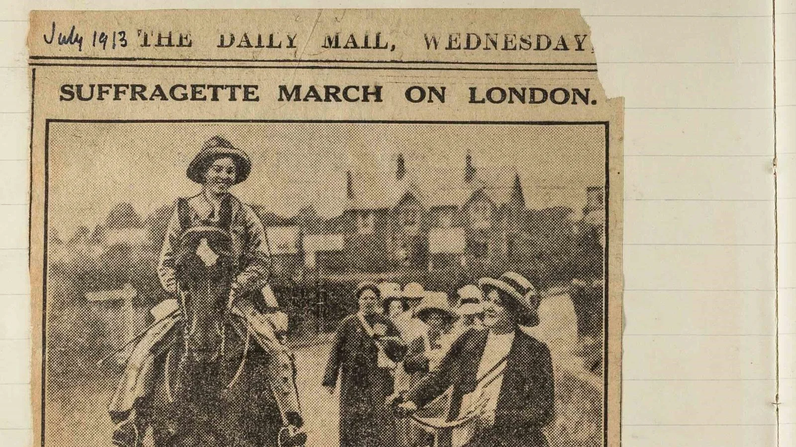 Newspaper cuttings about a suffrage march. In a diary.