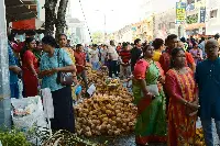 A crowd of people gathered in the street, waiting.