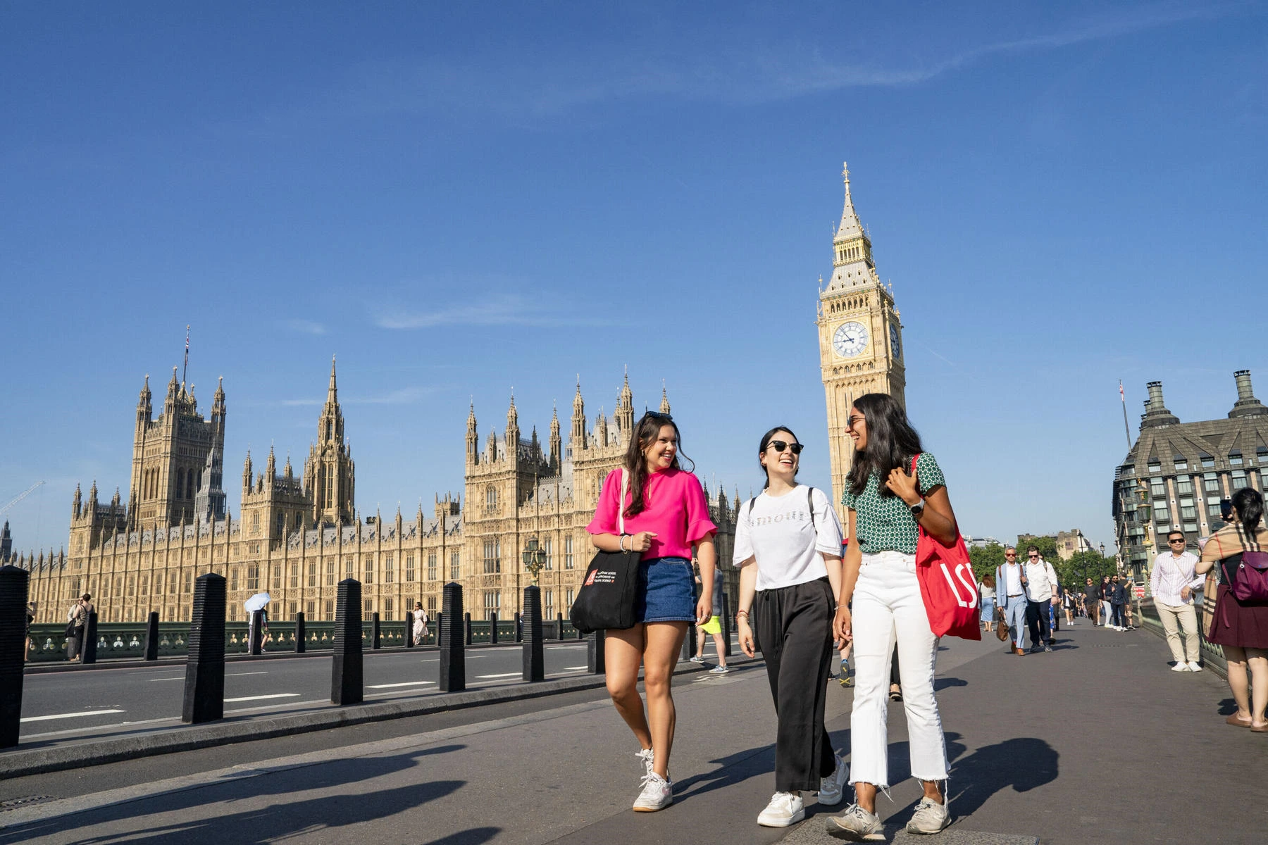 LSE students walking around Westminster in London with the Houses of Parliament in the background