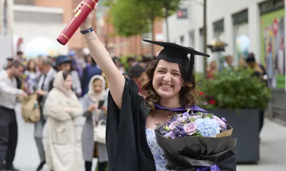 LSE graduate with flowers