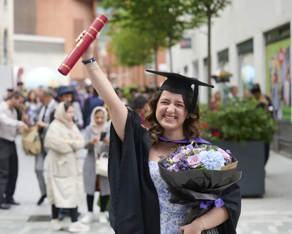 LSE graduate with flowers