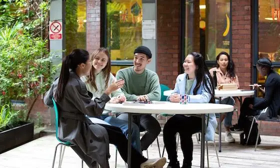 Students sat at a garden table