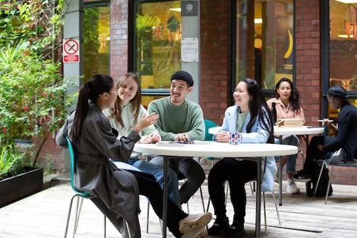 Students sat at a garden table