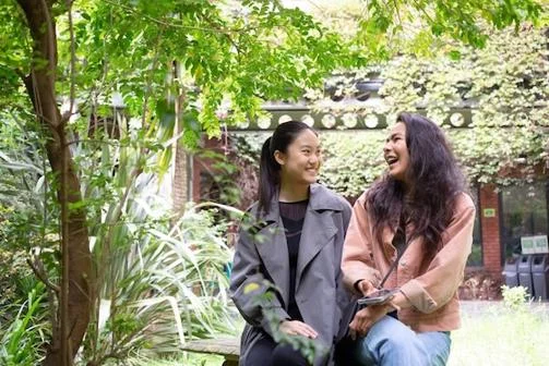 Students sat in a garden