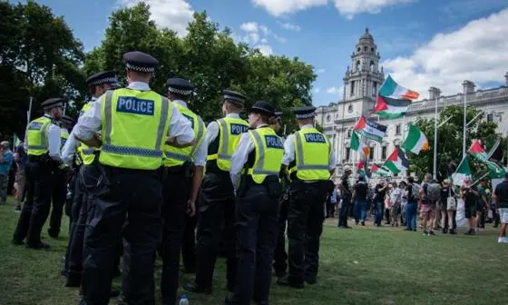 Police officers by Palestine protesters