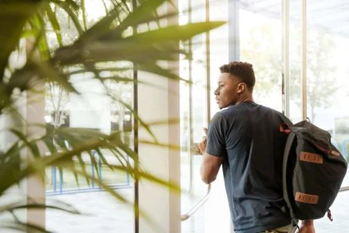 Global_Programmes_male_student_exiting_door