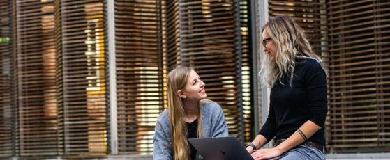 Global_Programmes_two_female_students_sat_on_steps-cropped-reversed