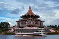 A boat in front of a building.