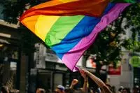 People waving a rainbow flag.