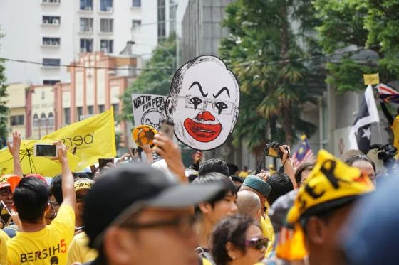 Bersih protesters holding a clown-like image of Najib Razak