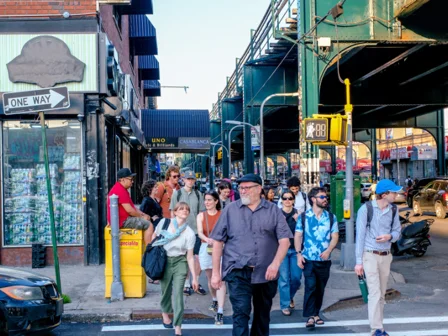 A group of people crossing a New York street