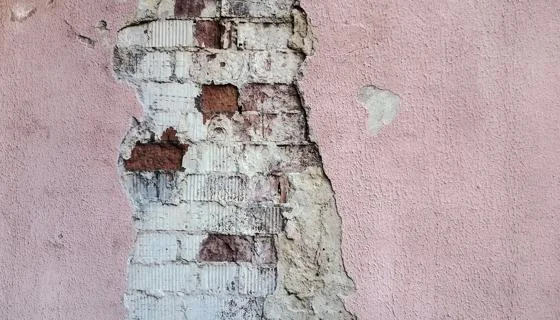 A wall with exposed brick
