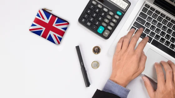 hands typing on laptop uk