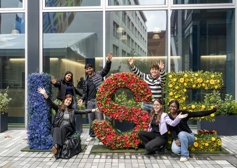 LSE students with the floral LSE letters on campus