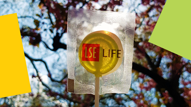 Lollipop with LSE LIFE written on it and trees and sunshine