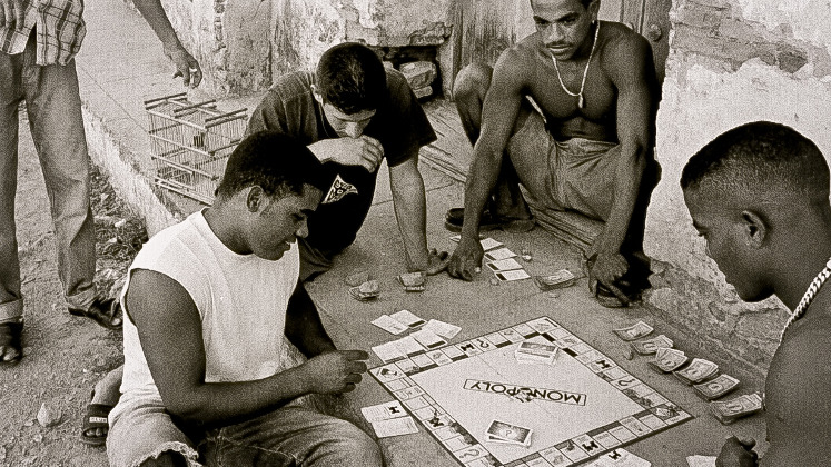 young men playing Monopoly in the street in Cuba