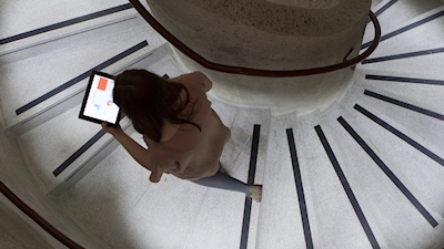 Student on stairs with laptop
