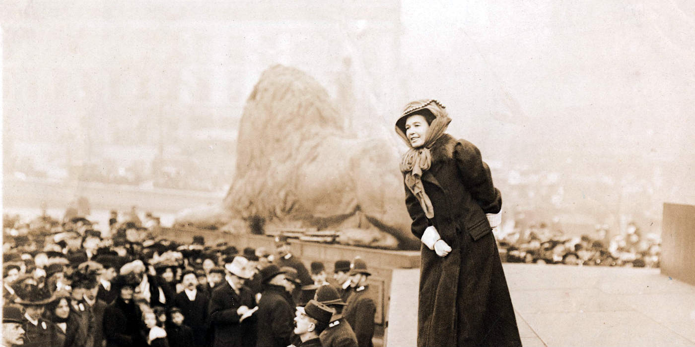 A woman talking to a crowd at Trafalgar Square in London.
