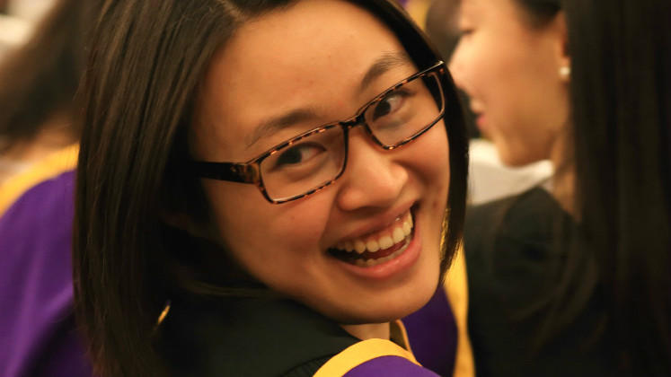 Graduate smiles over her shoulder