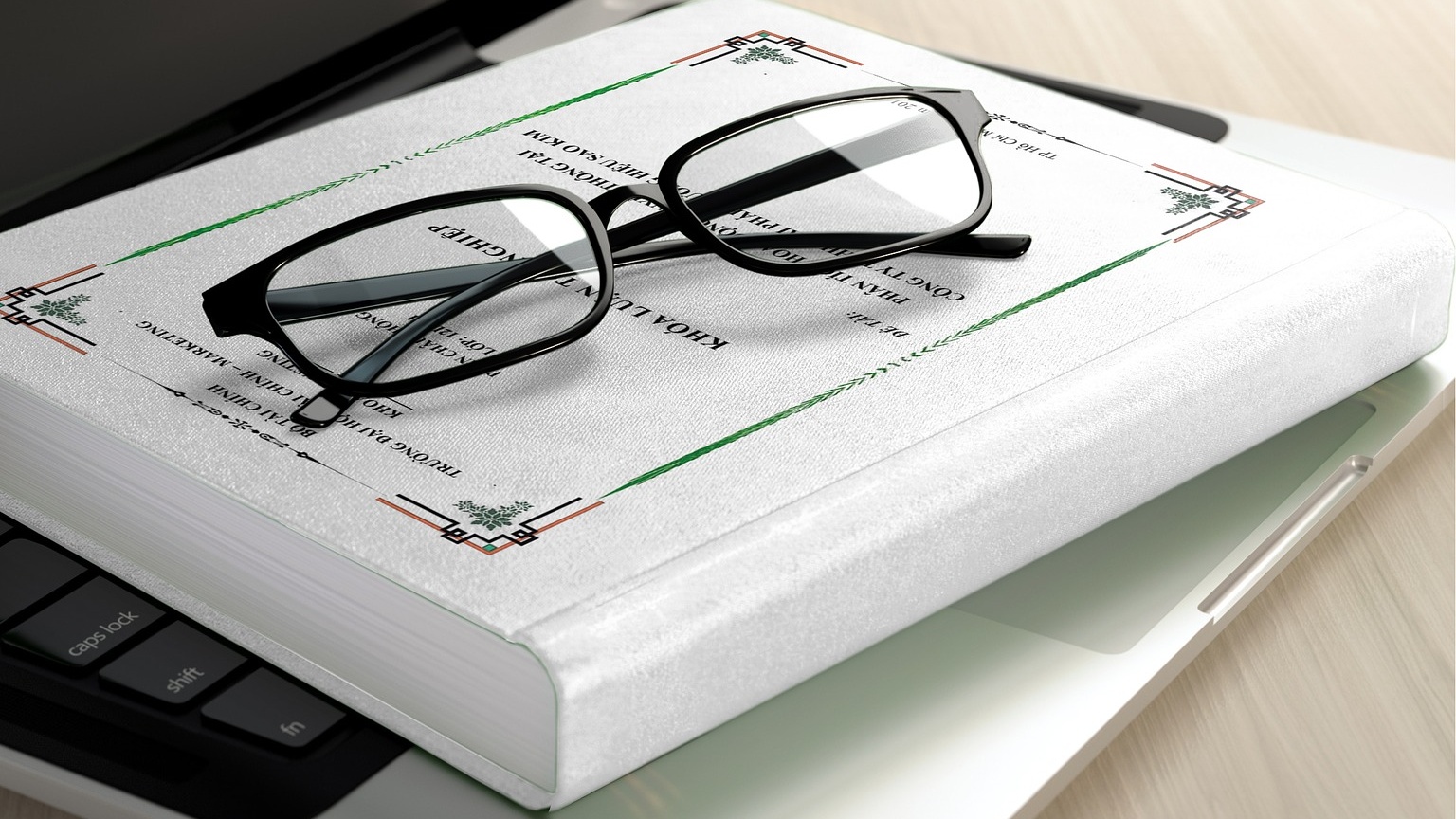 A pair of glasses on a closed book