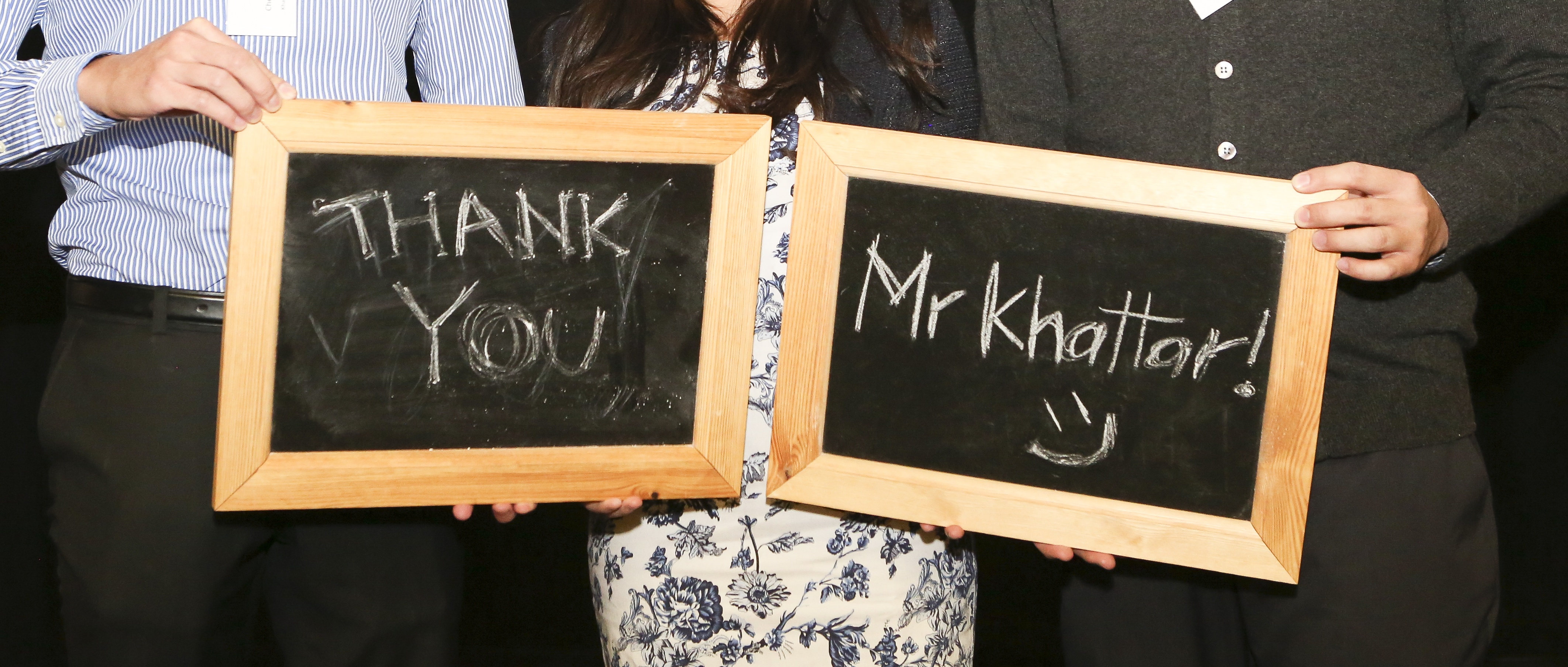 Scholars holding chalk boards thanking Mr Khattar