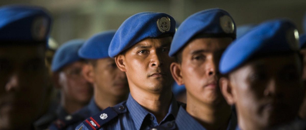 UN peacekeepers in blue berets in a line