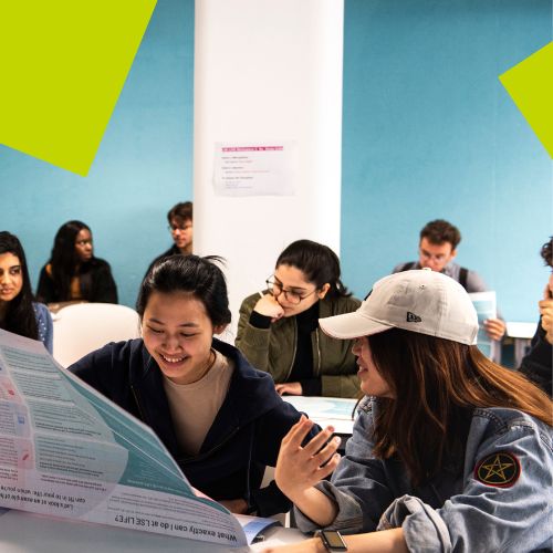 Two students reading a leaflet