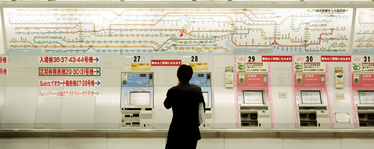 Tokyo subway person looking at ticket machine