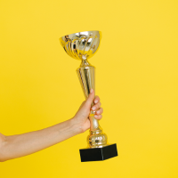 Hand_holding_trophy_stock_umage_sourced_via_canva_200x200