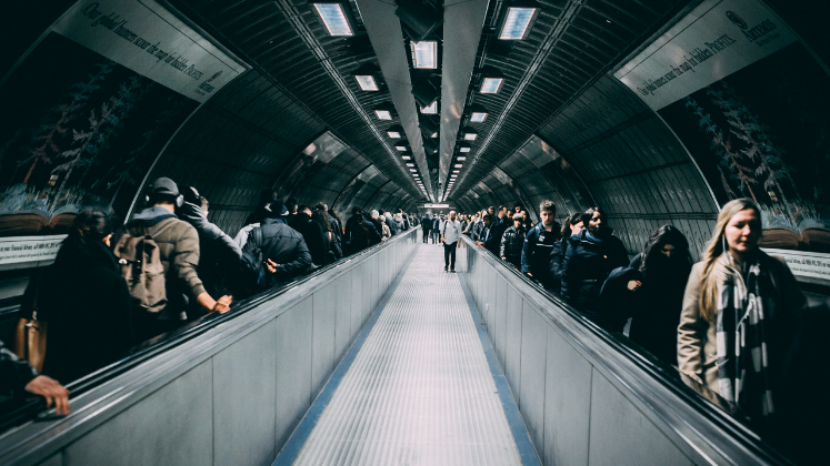 Crowded London underground escalators_image via Canva 747x420