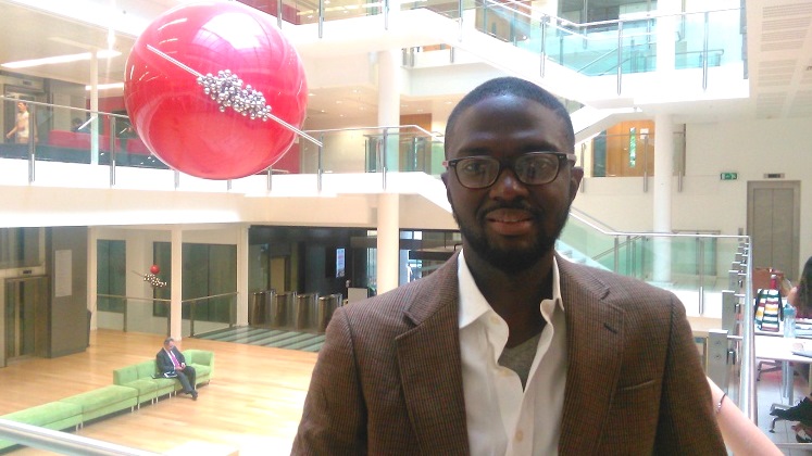Atta Addo standing in a large foyer of a building | LSE researcher profiles