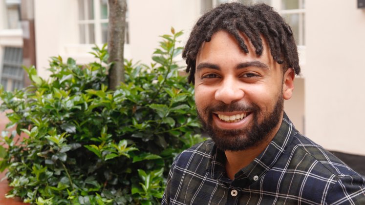 A smiling man in an outdoor setting | Celestin Okoroji | researcher at LSE