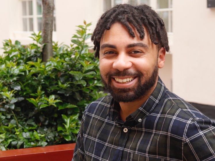 A smiling man in an outdoor setting | Celestin Okoroji | researcher at LSE
