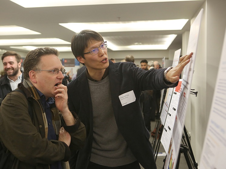 Young-ook Jang explains his poster at the LSE Research Festival | LSE Festival research competition