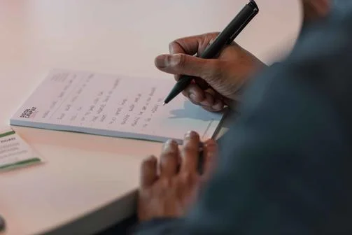 Close up of person handwriting notes