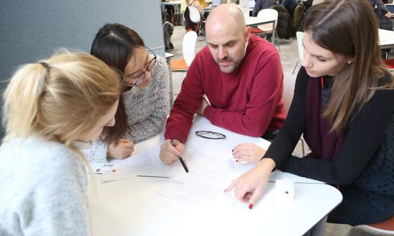 A group of students sitting with an advisor at a LSE LIFE session