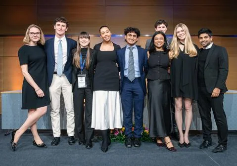 A group of students in formalwear smiling at the camera
