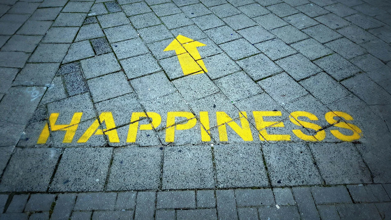 Happiness with an arrow printed on a pavement
