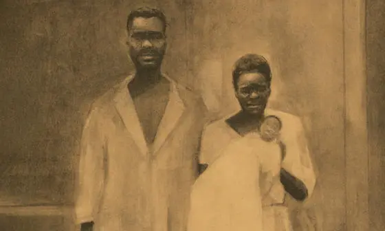 Two enslaved people holding a baby