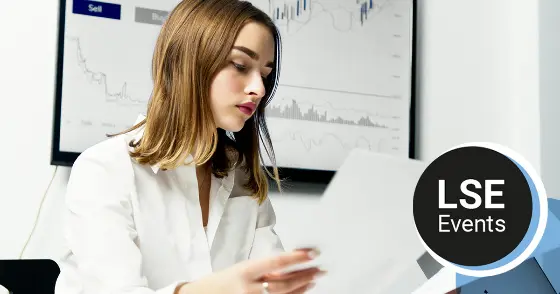 A woman looking at sheets of paper