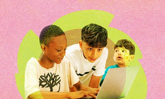 Three boys working on a laptop