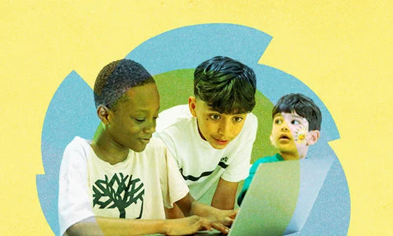 Three boys working on a laptop